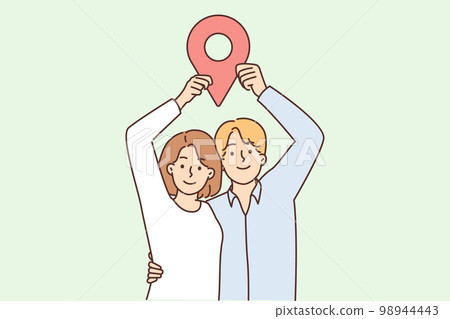 Man and woman stand in embrace and show large geotag to share coordinates for house party Man and woman stand in embrace and show large geotag to share coordinates for house party 98944443