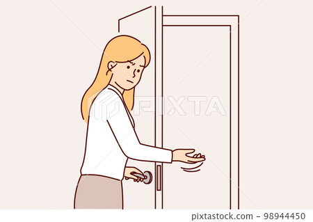 Disgruntled woman secretary invites to enter room opening door for unpleasant person Disgruntled woman secretary invites to enter room opening door for unpleasant person 98944450