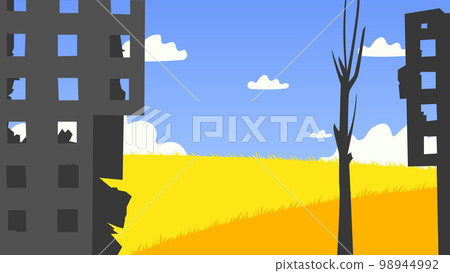 Destroyed buildings in front of a yellow field and blue sky Destroyed buildings in front of a yellow field and blue sky 98944992