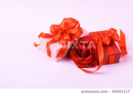 Happy Valentine's Day, Mother's Day and birthday greeting card. Red rose and gift boxes with a satin ribbon bow 98945317