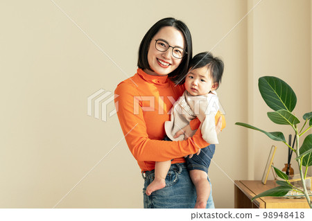 A mother holding a baby 98948418