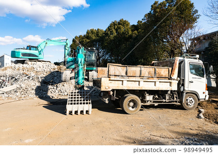 Housing complex demolition construction site Heavy equipment backhoe and dump truck 98949495