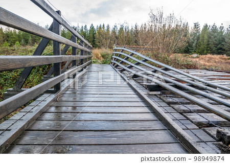An old, rotten wooden bridge over the Owenea river by Ardara in County Donegal - Ireland An old, rotten wooden bridge over the Owenea river by Ardara in County Donegal - Ireland 98949874