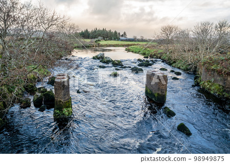 An old, rotten wooden bridge over the Owenea river by Ardara in County Donegal - Ireland An old, rotten wooden bridge over the Owenea river by Ardara in County Donegal - Ireland 98949875