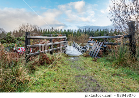 An old, rotten wooden bridge over the Owenea river by Ardara in County Donegal - Ireland An old, rotten wooden bridge over the Owenea river by Ardara in County Donegal - Ireland 98949876