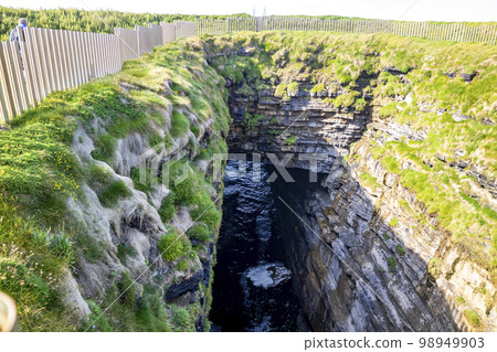 The blowhole at Downpatrick Head In County Mayo - Ireland The blowhole at Downpatrick Head In County Mayo - Ireland 98949903