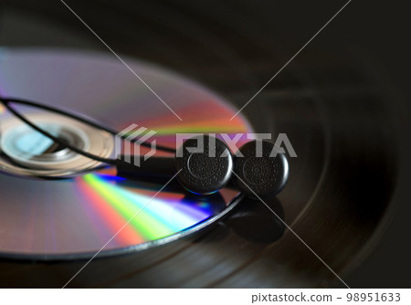 Vinyl record, disk, earphones on the player. Close up 98951633