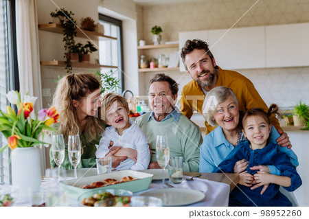 Portrait of happy multigenerational family during Easter dinner. Portrait of happy multigenerational family during Easter dinner. 98952260