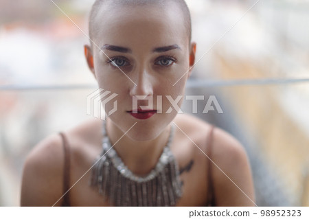 Portrait of unhappy pensive woman with cancer. 98952323