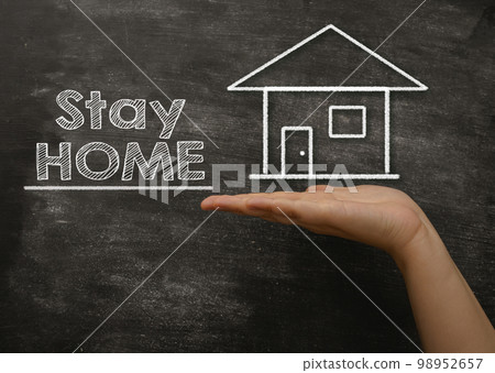Composition with text Stay Home drawn on black chalkboard Composition with text Stay Home drawn on black chalkboard 98952657