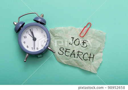 Composition with text Job Search and alarm clock on blue Composition with text Job Search and alarm clock on blue 98952658