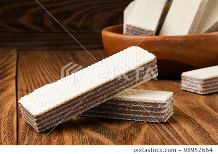 Wafers biscuit close-up on a wooden background. Wafers biscuit close-up on a wooden background. 98952664