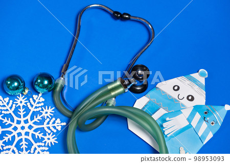 Christmas and New Year Medicine - Stethoscope, Snowmen and Snowflakes on a Blue Background, Top View 98953093
