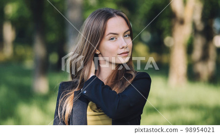 Portrait of a young student in a city park. 98954021