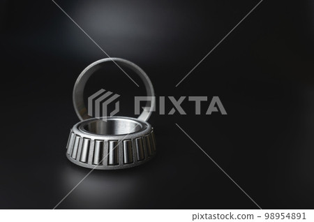 new two-piece roller bearing on a black background. Metal spare part for car suspension 98954891