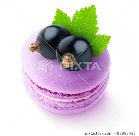 Close-up of two black currant berries on top of pink macaroon isolated on white background Close-up of two black currant berries on top of pink macaroon isolated on white background 98955435