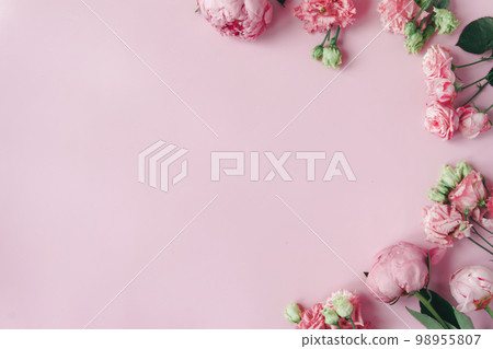 Peonies, roses on pink background with copy space. Abstract natural floral frame layout with text space. Romantic feminine composition. Wedding invitation. International Women day, Mother Day concept 98955807