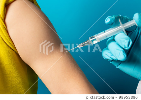 The doctor or nurse injects the child in the arm' in the shoulder. The concept of vaccination in health and medicine, vaccines for children. BCG tuberculosis, DPT. 98955886