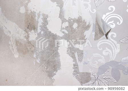 The wall after removing the wallpaper - traces of plaster on the concrete surface. Renovation in the apartment with traces of old wallpaper The wall after removing the wallpaper - traces of plaster on the concrete surface. Renovation in the apartment with traces of old wallpaper 98956082