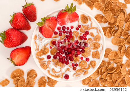 Cereals drenched in milk - quick breakfast with fruits and berries, top view 98956132