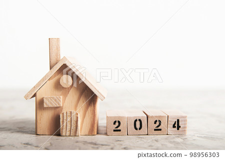 Happy New Year minimal concept with house model on table background 98956303
