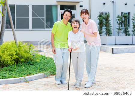 A senior woman and her caregiver taking a walk outdoors with a cane Cooperation: Chuo College of Technology Japanese Language School A senior woman and her caregiver taking a walk outdoors with a cane Cooperation: Chuo College of Technology Japanese Language School 98956463