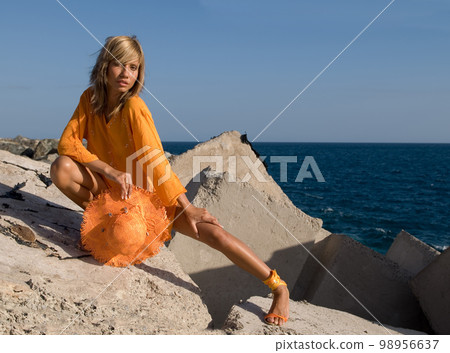 Attractive young woman in a coastal environment near the sea 98956637