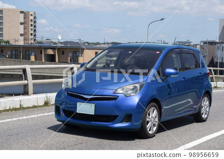 Compact car road driving 98956659