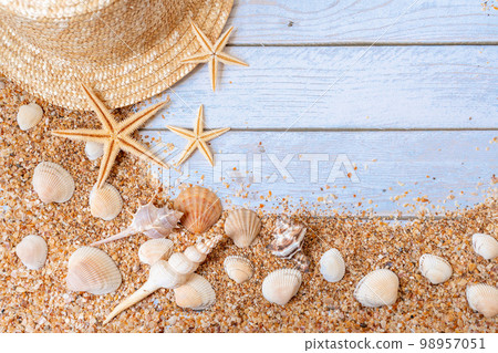Sand seashells background. Summer time concept with sea shells and starfish on wooden background and sand 98957051