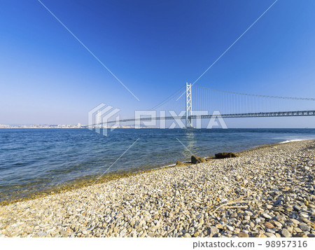 Akashi Kaikyo Bridge seen from the coast of Awaji City / Akashi Kaikyo Bridge, Japan Akashi Kaikyo Bridge seen from the coast of Awaji City / Akashi Kaikyo Bridge, Japan 98957316