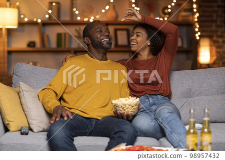 Playful african american lovers having fun at cozy house 98957432