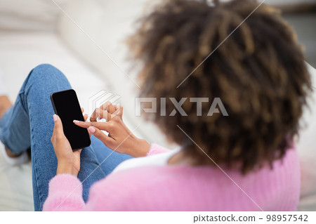 High angle view of african american woman using phone, mockup High angle view of african american woman using phone, mockup 98957542