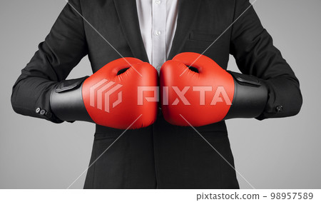 Cropped Shot Of Young Businessman Wearing Boxing Gloves And Suit 98957589