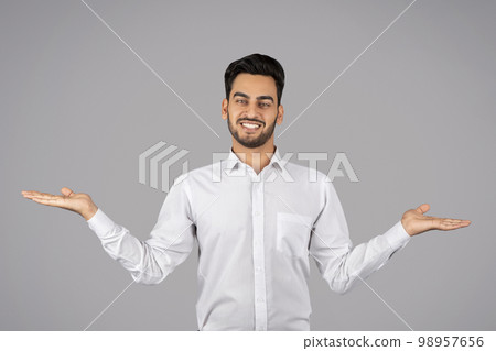 Make Your Choice. Young arab businessman making scales with his empty palms 98957656