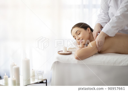 Spa Day. Beautiful Indian Woman Enjoying Relaxing Massage In Salon 98957661