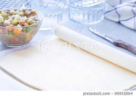 Making individual beef pot pies, step 2 roll the dough, horizontal 98958864