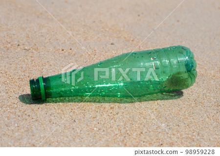 Green plastic bottle on the beach Green plastic bottle on the beach 98959228