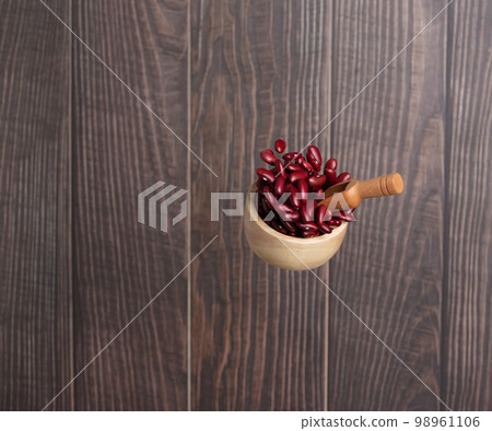 Red Bean flying explosion in wood bowl, red grain beans explode abstract cloud fly. Beautiful complete seed pea bean bowl splash in air, food object design. Wooden background isolated freeze shot 98961106