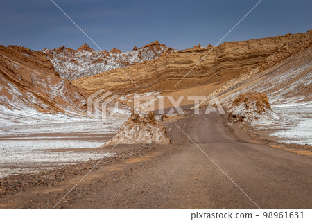 Dirt road in Moon Valley dramatic landscape at Sunset, Atacama Desert, Chile 98961631