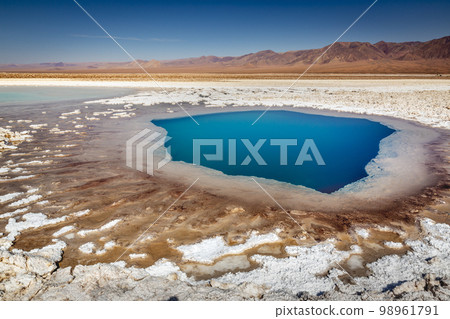 Salt lake, volcanic landscape at sunrise, Atacama, Chile border with Bolivia 98961791