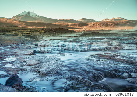 Geysers El Tatio with river and volcanic landscape at sunrise, Atacama, Chile 98961818