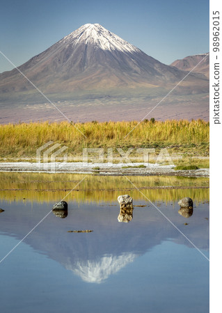 Licancabur with reflection lake and volcanic landscape at Sunset, Atacama, Chile Licancabur with reflection lake and volcanic landscape at Sunset, Atacama, Chile 98962015