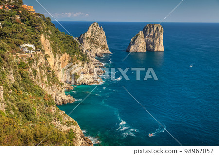 Above Capri city cliffs and Faraglioni with boats and yacht, amalfi coast, Italy Above Capri city cliffs and Faraglioni with boats and yacht, amalfi coast, Italy 98962052