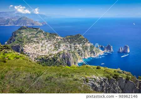 Above Capri city cliffs and Faraglioni with boats and yacht, amalfi coast, Italy 98962146