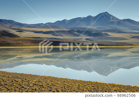 Salt lake, volcanic landscape at Sunset, Atacama, Chile border with Bolivia 98962506