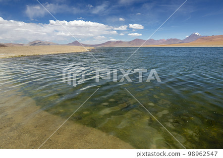 Salt lake, volcanic landscape at sunrise, Atacama, Chile border with Bolivia 98962547