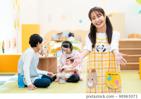 Nursery teacher working at a nursery school 98963071