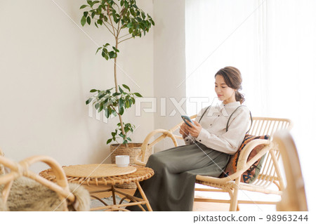 A woman relaxing in the room A woman relaxing in the room 98963244