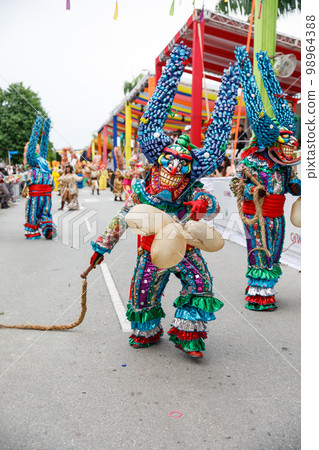 A man in a carnival costume and mask. A man in a carnival costume and mask. 98964388