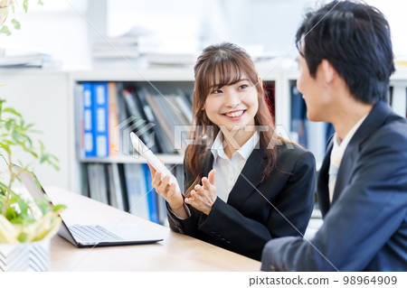 People having a meeting using a calculator People having a meeting using a calculator 98964909